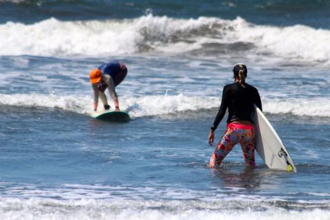 Heading out to coach Amigas into waves.